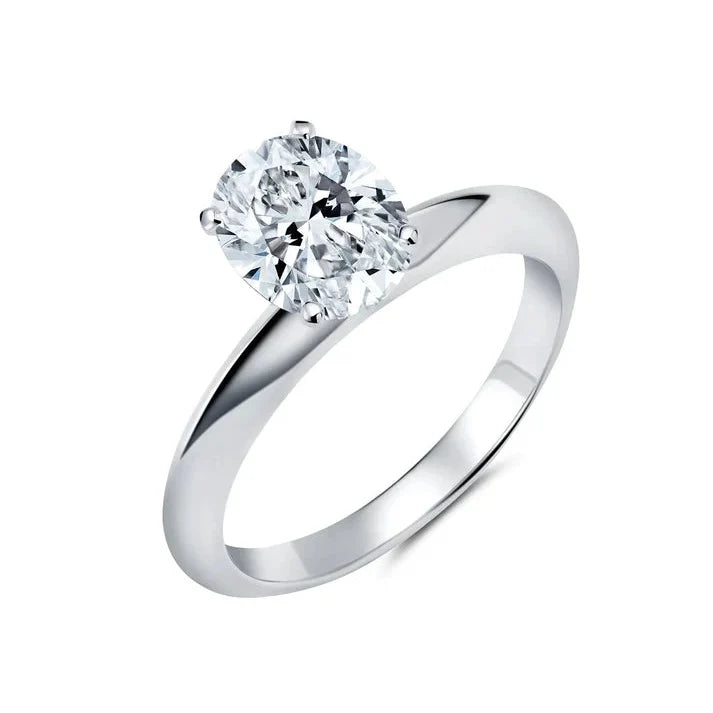 Silver-toned ring with a large, brilliant oval-cut clear cubic zirconia stone held by four prongs on a polished band.