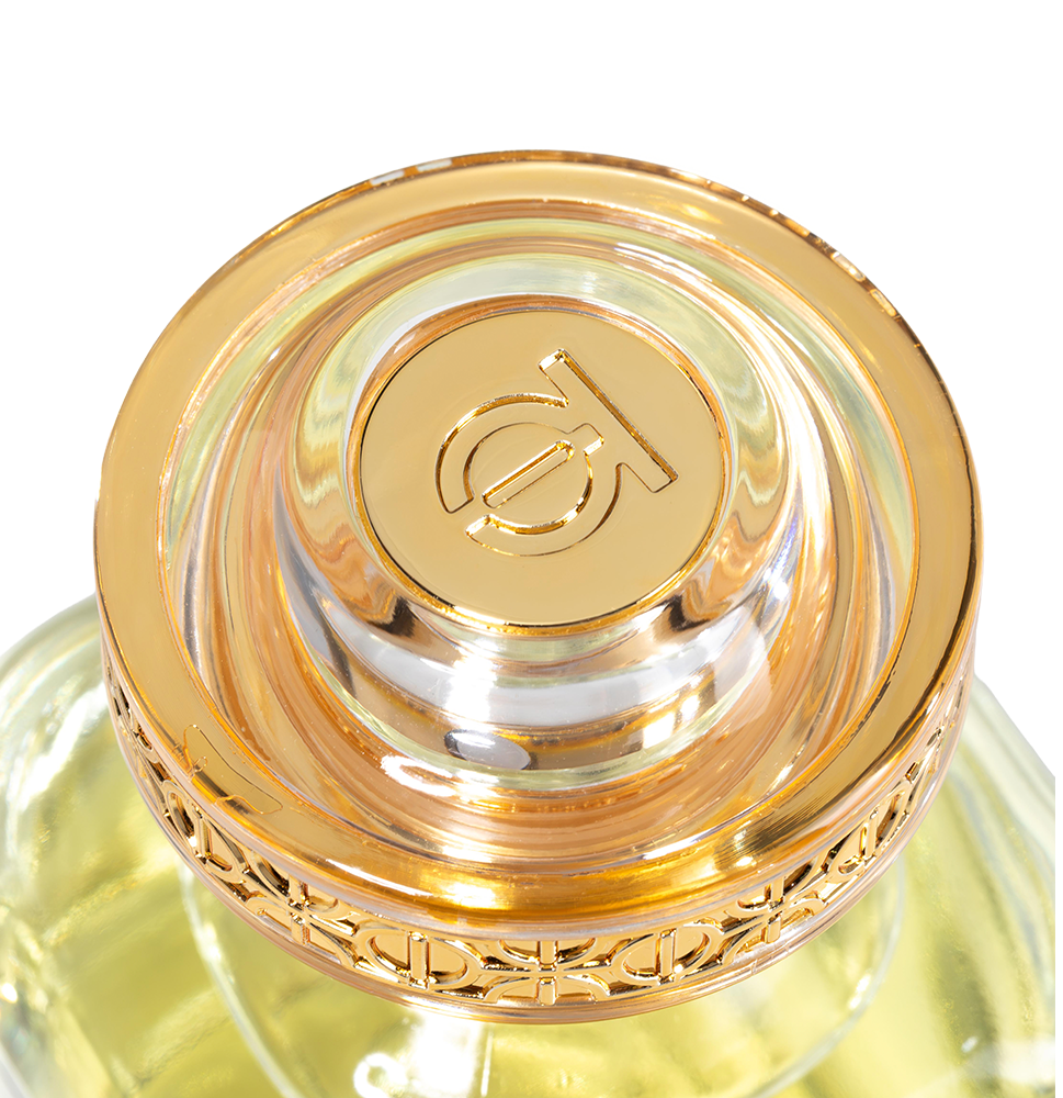Close-up view of the intricate gold and acrylic brand-monogrammed cap on the Touch of Oud Salwan fragrance bottle, featured on Paris Gallery Qatar.