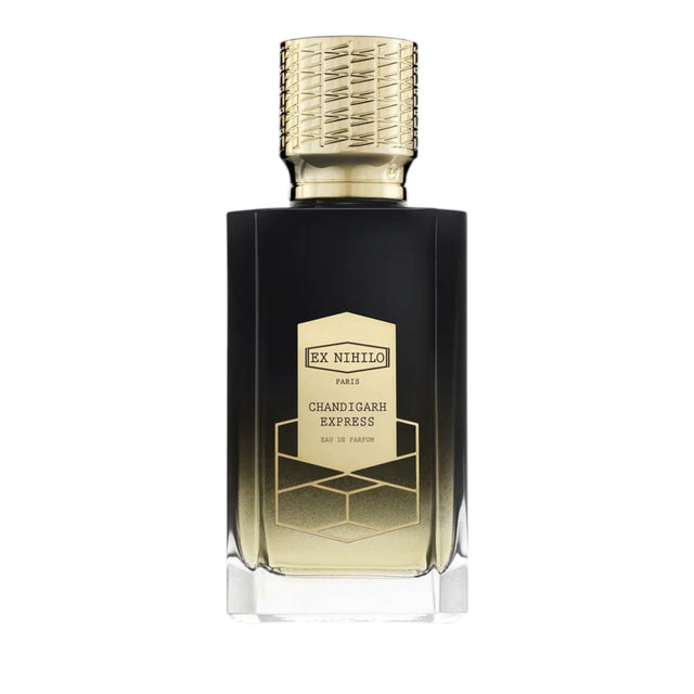 Black and gold-toned faceted glass perfume bottle with a patterned gold cap and a label featuring geometric design.