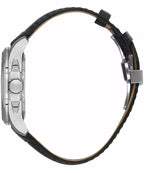 Side view of a watch with a silver-toned case, crown, and pushers. It has a black textured leather band with a silver-toned d